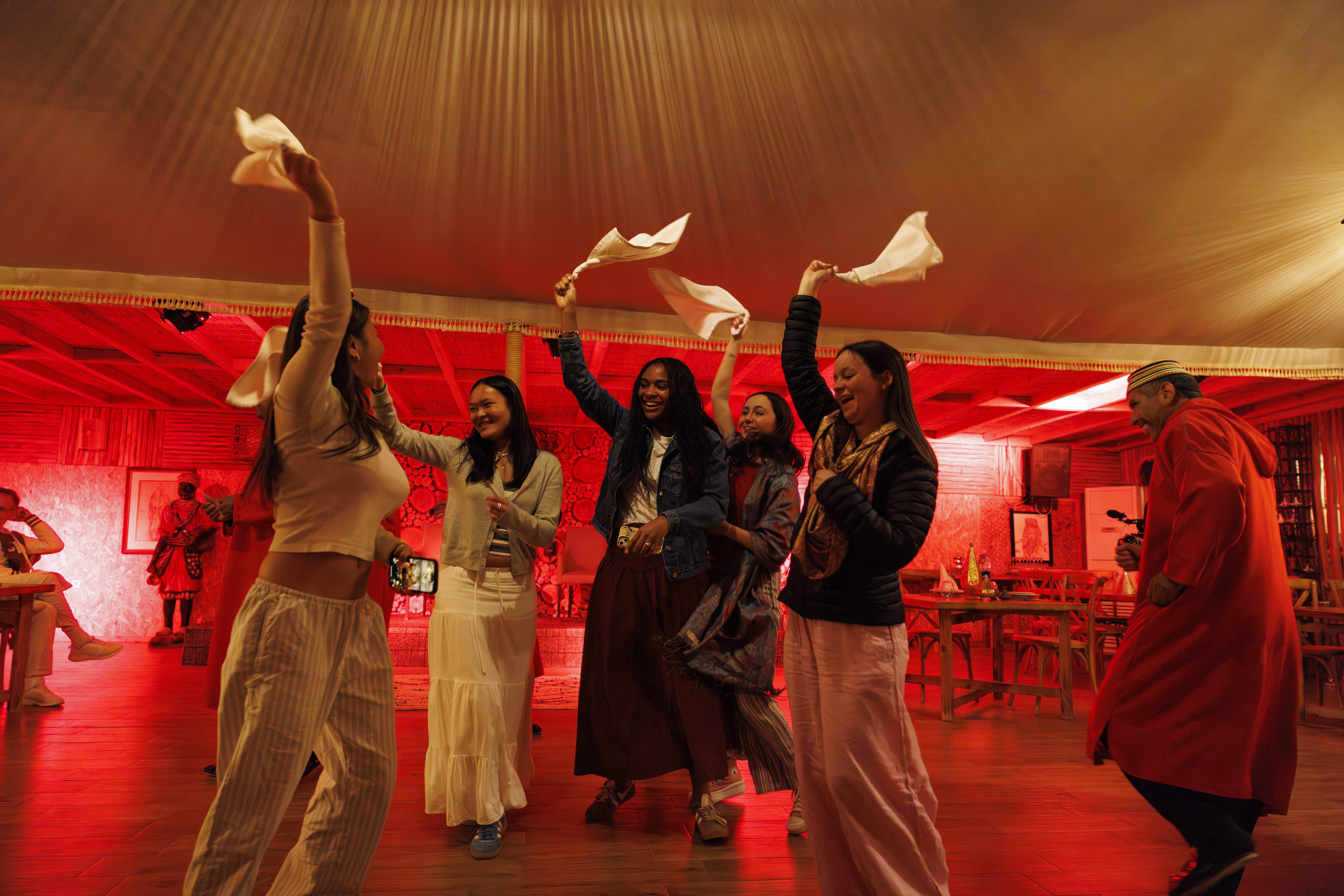 students dancing and waving flags