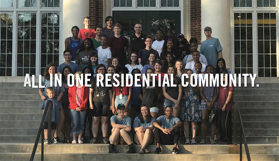 video still of group of students on steps of a building