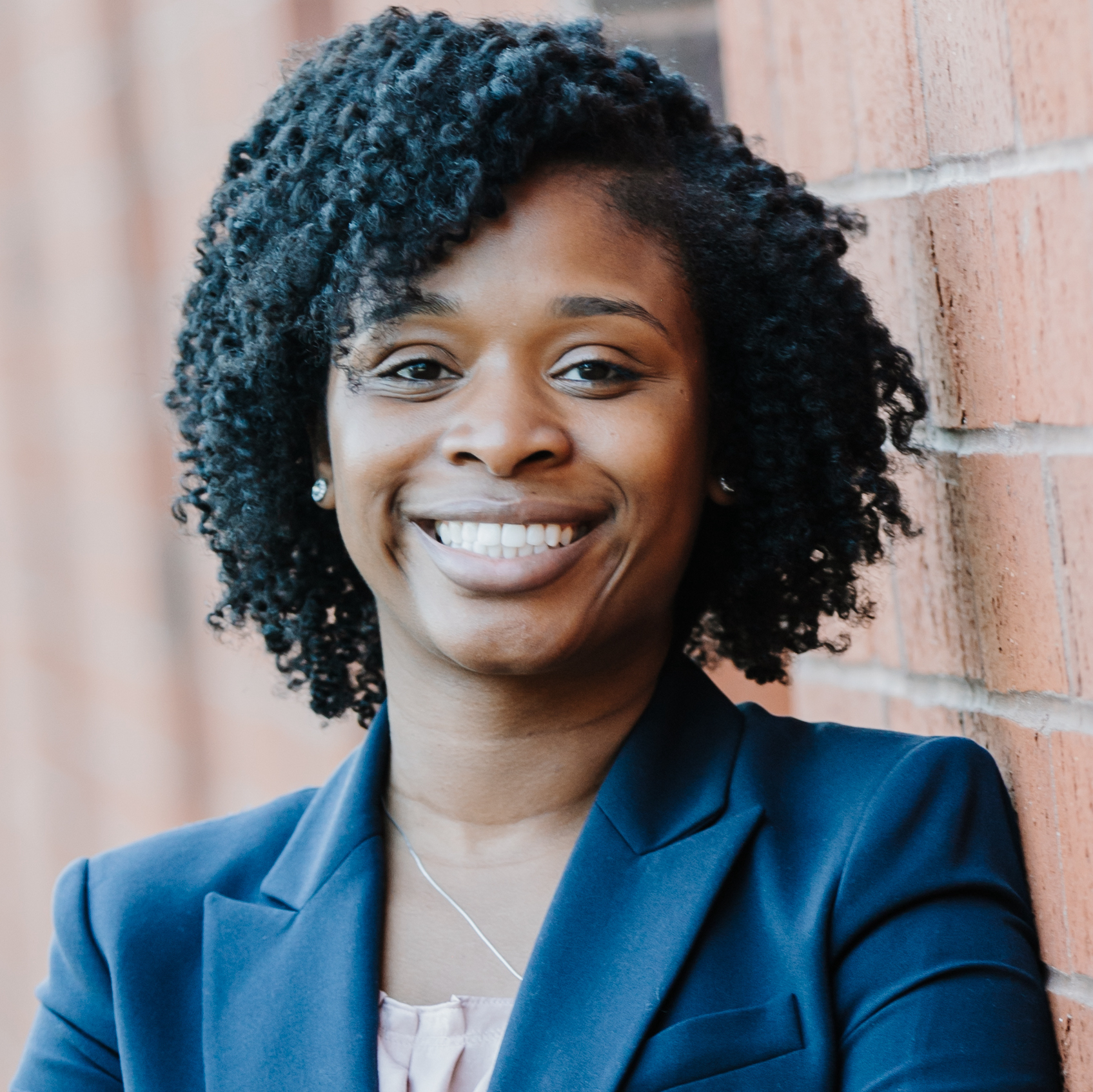 headshot of photo woman, with wall