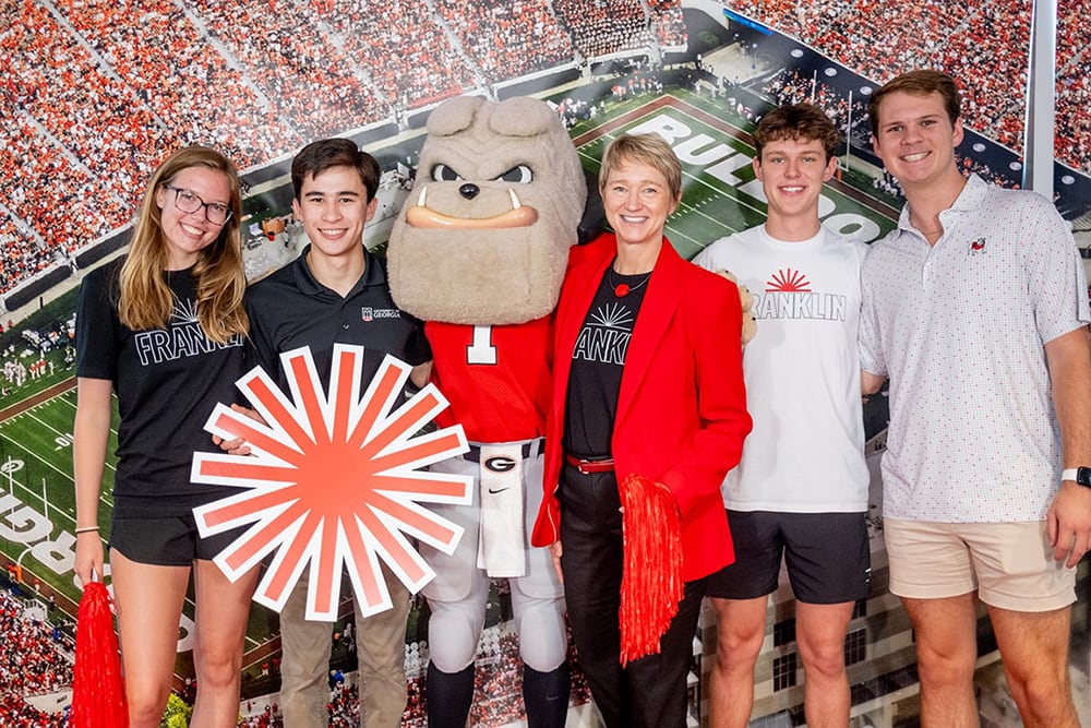 Franklin College students posing with Dean Stenport and UGA's mascot Hairy Dawg