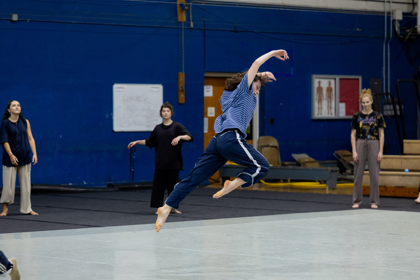 Ava Grau leaping in gym