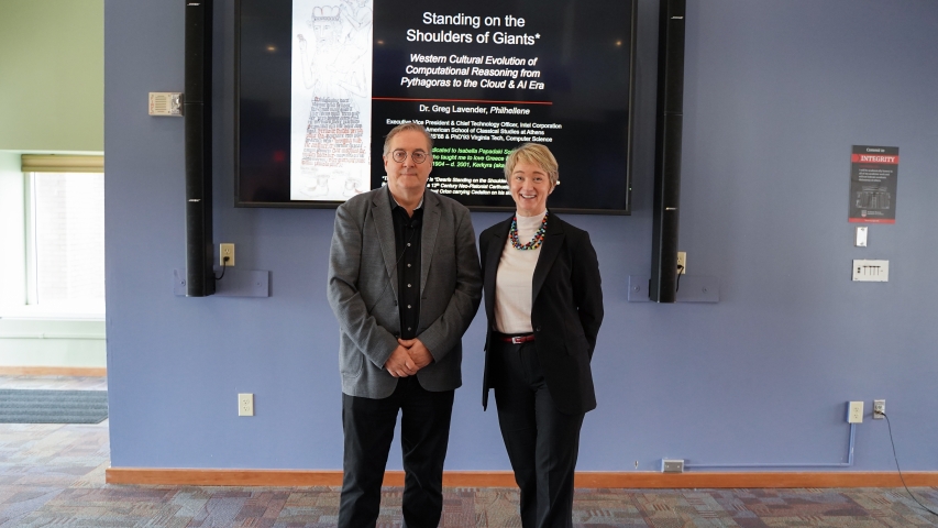 photo of two people, screen in background