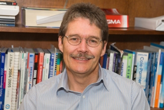 photo of man with bookshelves