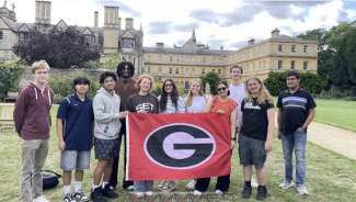 Pictured: Computing students holding up flag at Oxford 