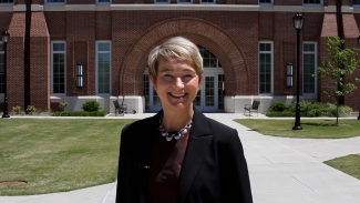 photo of woman with building in background, day