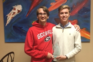 two students in front of a painting