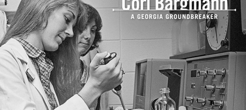 black and white photo of two people in a lab, woman in foreground 