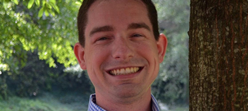 man outside with tree