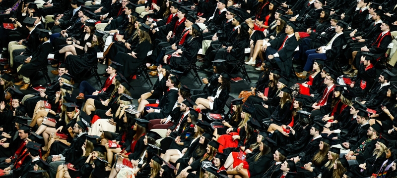 photo of seated people in caps and gowns