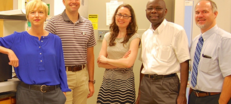 photo of four people in a lab