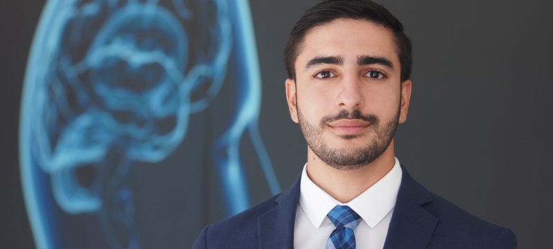 photo of man with design on screen in background