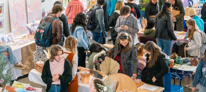 photo of people browsing tables at art market