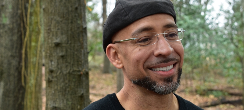 photo of man in forest, trees in background, day