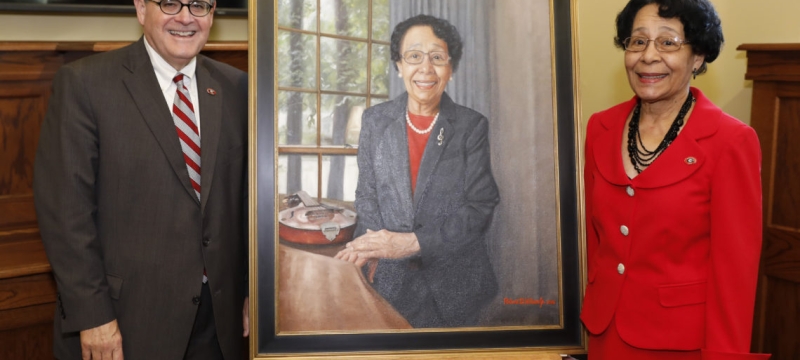 photo of two people with a painted portrait