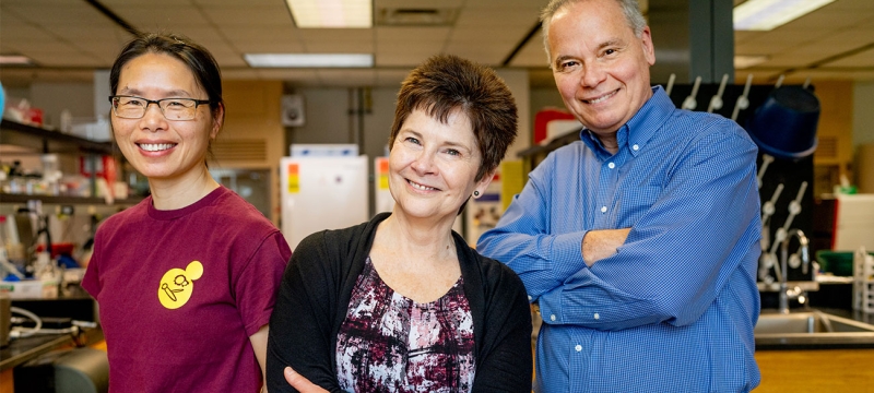 photo of three people in a laboratory 