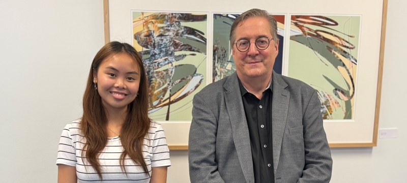 photo of two people, painting in background