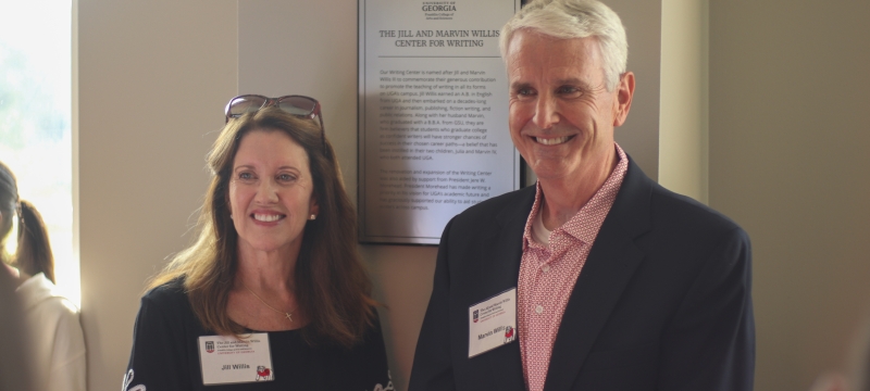 photo of woman and man, framed proclamation in background