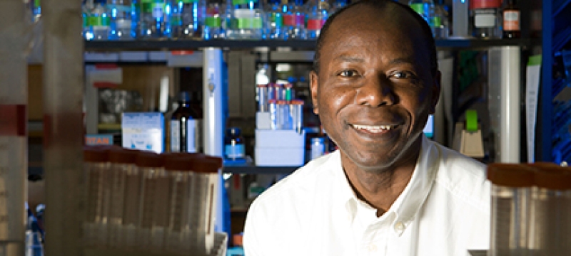 man in lab with beakers, bottles