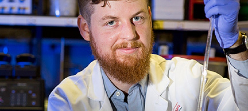 man in lab with syringe 