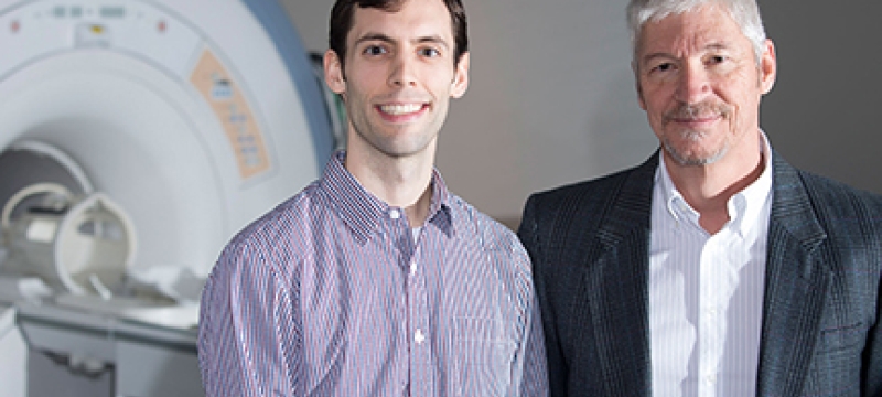 two men with fMRI machine 