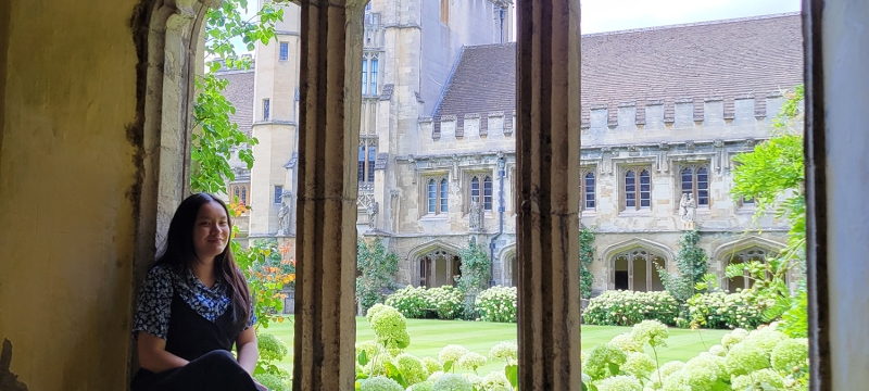 photo of woman seated in triple window frame