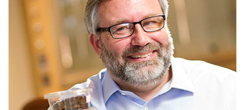 man in lab with plastic containers