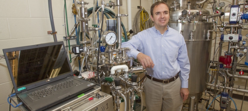 photo of man with fermentation equipment