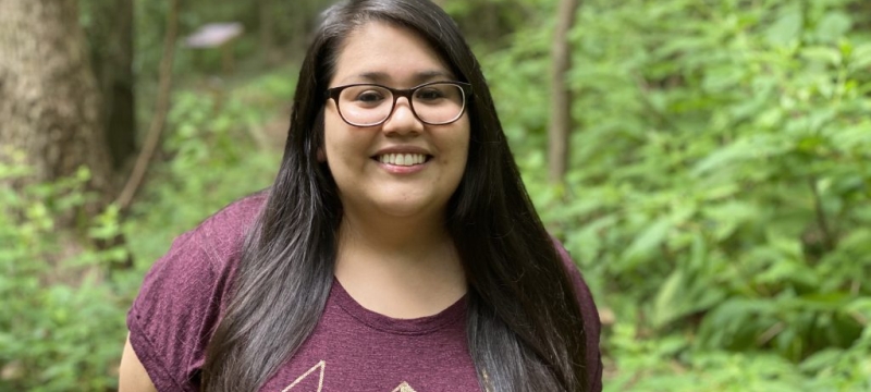 photo of woman outdoors, trees in background