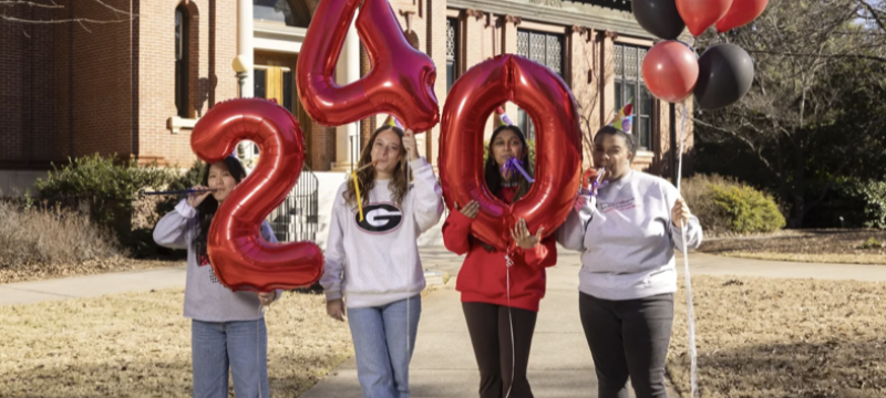 photo of students holding inflatable numbers, balloons, day