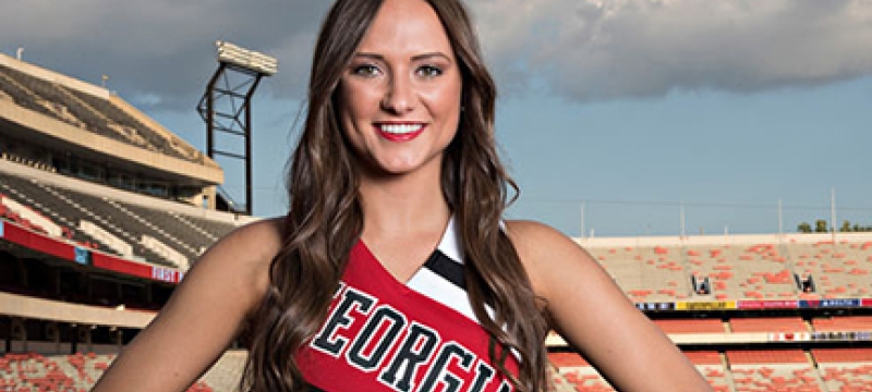 cheerleader in uniform with stadium