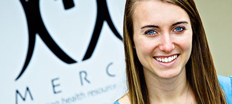 woman in front of hospital sign