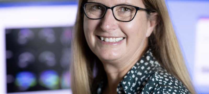 photo of woman with computer screen in background