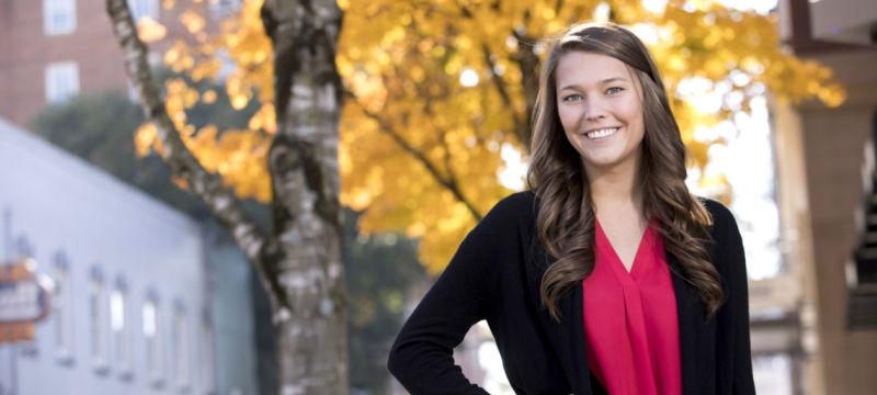 photo of woman outdoors with tree and fall foliage