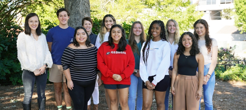 photo of group of people, outdoors, tree in background