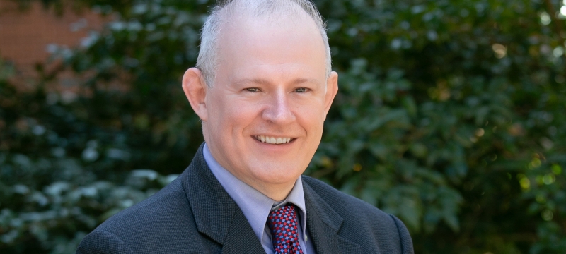 headshot photo of man, outdoors, day