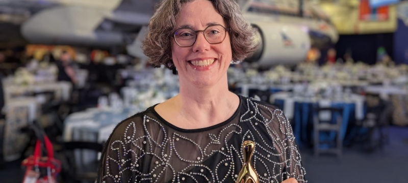 photo of woman with award trophy