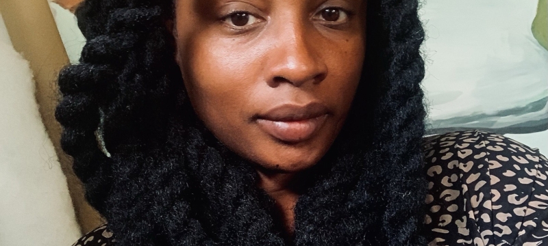 headshot of woman, with painting in background