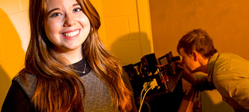 woman, with man looking at instrument