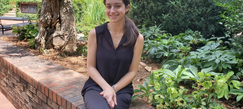 photo of woman posed on low wall, day