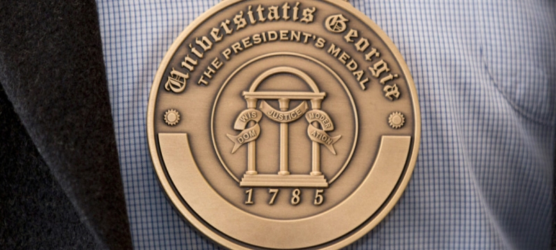 photo of engraved medal, shirt and jacket