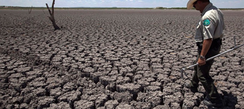 man walking on dried ground