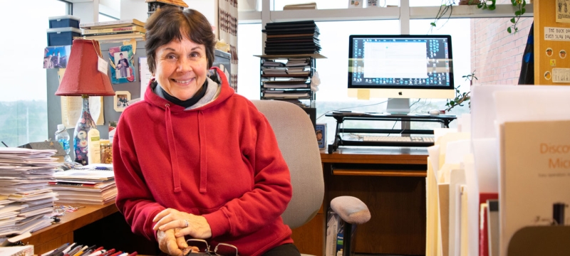 photo of woman in office, with windows, day