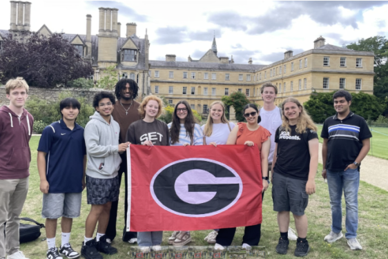 Pictured: Computing students holding up flag at Oxford 